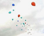 Balloons released in a cloudy sky